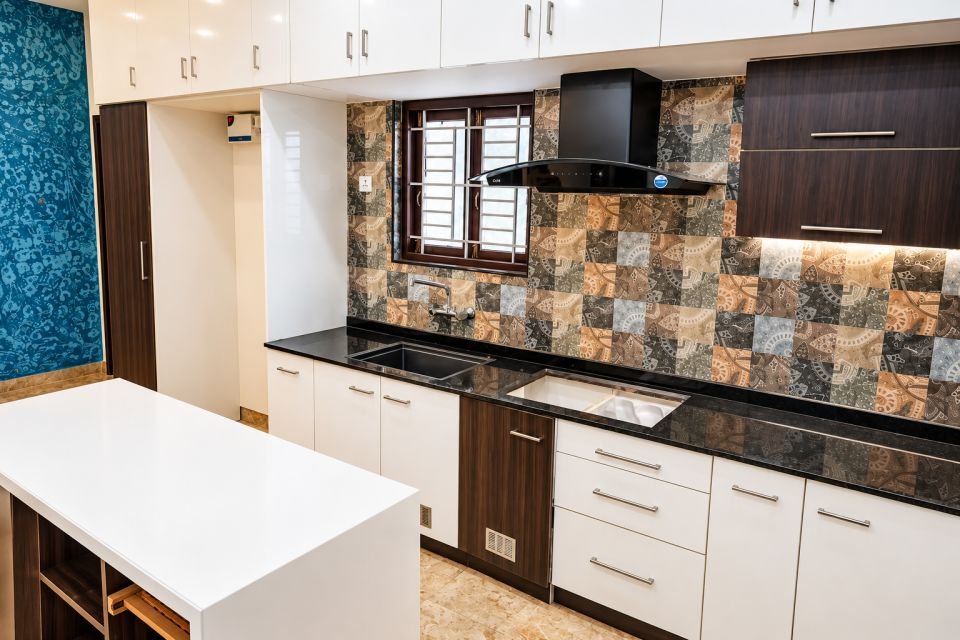Kitchen with patterned tile backsplash and island