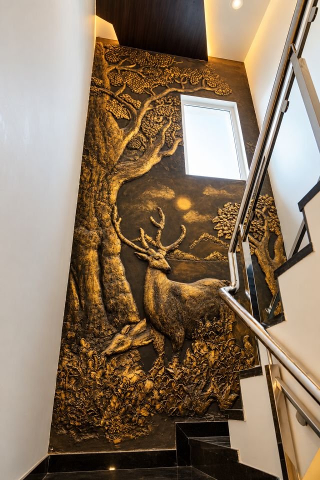 Stairwell with a bronze forest mural wall