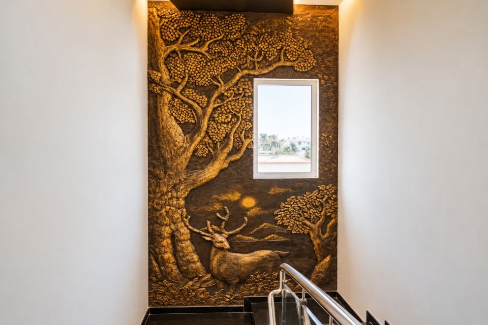 Bronze relief mural of trees and deer