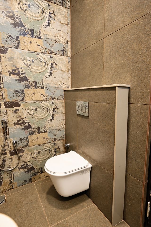 Wall hung toilet against patterned tiles